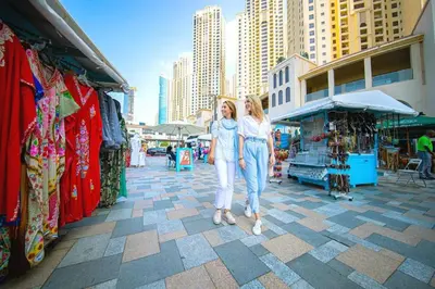two women standing next to each other in a market at Upgraded 3BR Jacuzzi & Comfort at JBR in Dubai