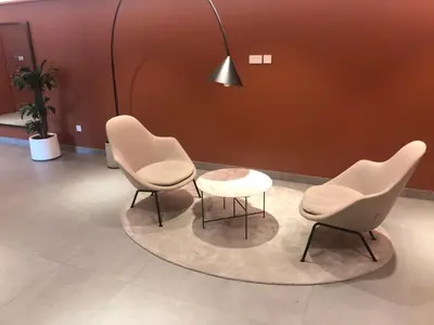 two chairs and a table in a waiting room at les voiles in Dubai
