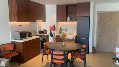 a kitchen with a table and chairs in a kitchen at les voiles in Dubai