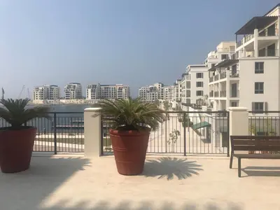 two potted plants on a balcony with buildings at les voiles in Dubai