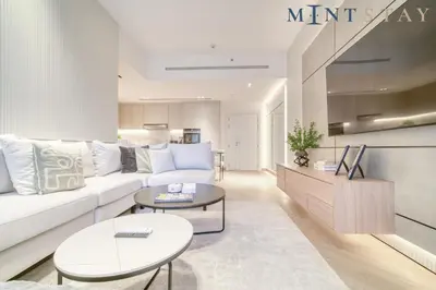 a living room with a white couch and a table at Silverene Tower B, Dubai Marina - Mint Stay in Dubai