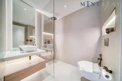 a white bathroom with a sink and a toilet at Silverene Tower B, Dubai Marina - Mint Stay in Dubai