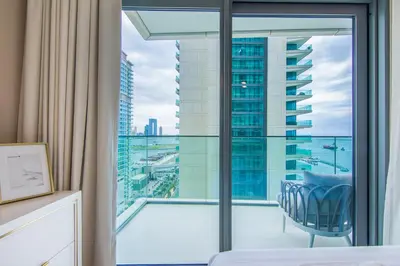 a bedroom with a view of a city at Privet Beach 2BR in Dubai Marina in Dubai