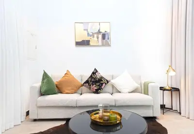 a living room with a couch and a table at EasyGo - Northside Tower 2 Canal View in Dubai