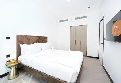 a bedroom with a large white bed and a mirror at EasyGo - Northside Tower 2 Canal View in Dubai