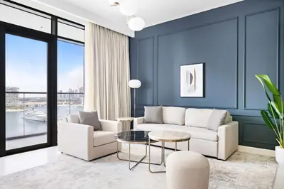 a living room with a couch and a table at Silkhaus Sea & Palm View 1BDR at Marina Vista in Dubai