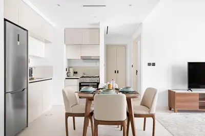 a kitchen and dining room with a table and chairs at Silkhaus Sea & Palm View 1BDR at Marina Vista in Dubai
