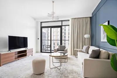 a living room with a couch and a tv at Silkhaus Sea & Palm View 1BDR at Marina Vista in Dubai