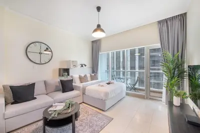 a living room with a couch and a table at HAVN - Studio in Downtown, Near Dubai Mall in Dubai