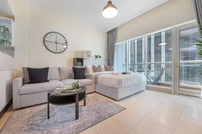 a living room with a couch and a table at HAVN - Studio in Downtown, Near Dubai Mall in Dubai