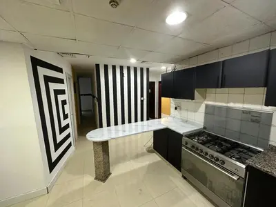 a kitchen with a counter and a stove in it at Stop Over Partition Room in Al Barsha 1 Near Mashreq Metro in Dubai
