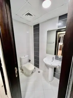 a bathroom with a toilet and a sink at Partition Room 5 Mins to Mashreq Metro in Dubai