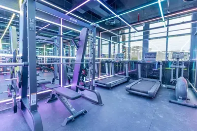 a gym with several tread machines in a building at GuestReady Holiday Homes - Arabian Elegance in JVC in Dubai
