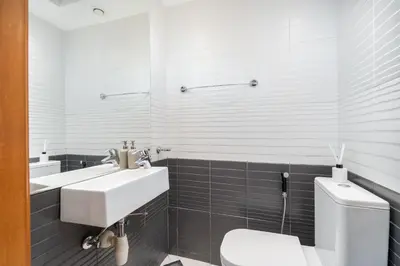 a white bathroom with a sink and a toilet at HAVN -1 Bedroom Apartment with Dubai Marina View in Dubai