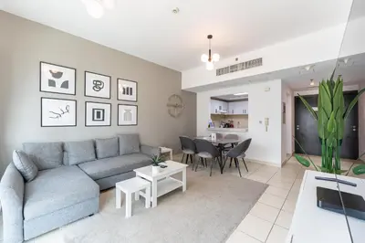 a living room with a couch and a table at HAVN -1 Bedroom Unit in Dubai Marina, Marina View in Dubai