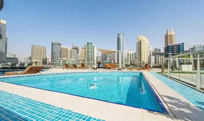 a swimming pool on the roof of a building with a city skyline at HAVN -1 Bedroom Unit in Dubai Marina, Marina View in Dubai