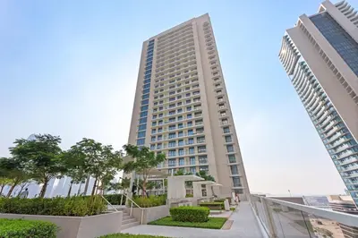 a tall building with two tall buildings at Silkhaus Full Marina View 2BDR in Unique New Tower in Dubai