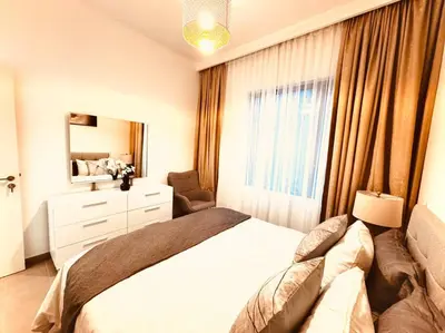 a bedroom with a white bed and a window at Park Heights Deluxe 1bedroom in Dubai