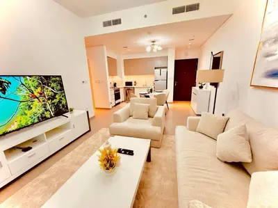 a living room with a couch and a tv at Park Heights Deluxe 1bedroom in Dubai