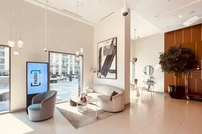 a living room with a couch and chairs and a table at Park Heights Deluxe 1bedroom in Dubai