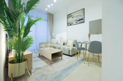 a living room with a couch and a table at Modern 1br Jvc Balcony & Free Parking Pool in Dubai