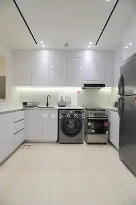 a kitchen with white cabinets and a dishwasher at Modern 1br Jvc Balcony & Free Parking Pool in Dubai