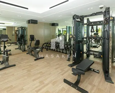 a gym with treadmills and machines in a room at Modern 1br Jvc Balcony & Free Parking Pool in Dubai