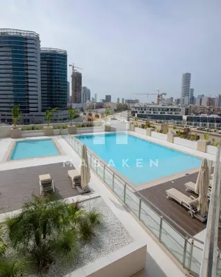 a swimming pool on the roof of a building at Modern 1br Jvc Balcony & Free Parking Pool in Dubai