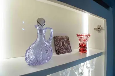 a shelf with a blue glass bottle and two vases at Veluxa - Fantastic 1 Bed - in Jumeirah Golf Estate! in Dubai