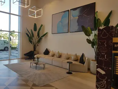 a living room with a couch and a table at Cosy 1 Bedroom in Damac Hills | OFEX in Dubai