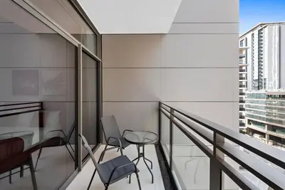 a balcony with chairs and a table in a building at StoneTree - Brand new Studio in Mohammed Bin Rashid City in Dubai
