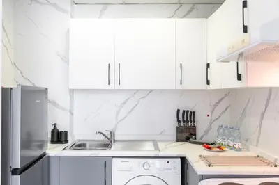 a kitchen with white cabinets and a dishwasher at HAVN - 2 Bedroom in Dubai Marina, 10min to Metro in Dubai
