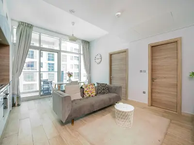 a living room with a couch and a large window at HAVN - 2 Bedroom Apartment with Dubai Marina View in Dubai