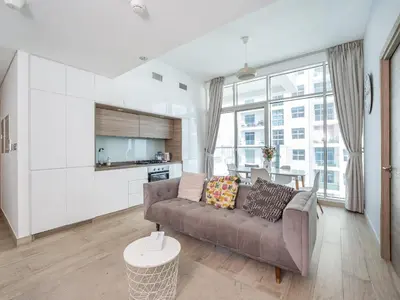 a living room with a couch and a kitchen at HAVN - 2 Bedroom Apartment with Dubai Marina View in Dubai