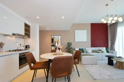 a kitchen and living room with a table and chairs at RH- Luxury Living, Central 1-Bedroom near DIFC, High Floor, 8 mins walk to Dubai Mall in Dubai