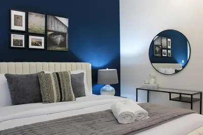 a bedroom with a large bed with a mirror at RH- Luxury Living, Central 1-Bedroom near DIFC, High Floor, 8 mins walk to Dubai Mall in Dubai