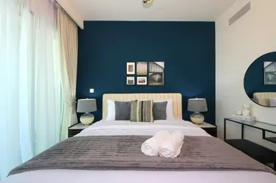 a bedroom with a large bed with two towels on it at RH- Luxury Living, Central 1-Bedroom near DIFC, High Floor, 8 mins walk to Dubai Mall in Dubai