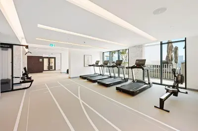 a gym with a row of treadmills and ellipticals at Silkhaus Exquisite Sea View 1BDR At Marina Vista in Dubai