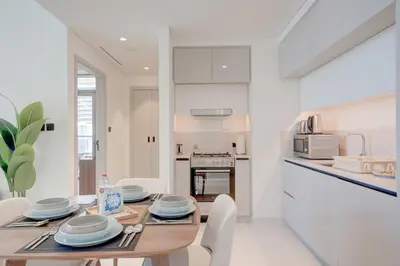a kitchen and dining room with a table and chairs at Silkhaus Exquisite Sea View 1BDR At Marina Vista in Dubai