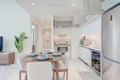 a kitchen and dining room with a table and chairs at Silkhaus Exquisite Sea View 1BDR At Marina Vista in Dubai