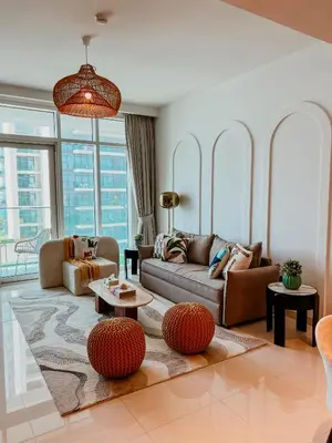 a living room with a couch and a table at Oceanfront Escape: Stylish 1 BR in Beachfront in Dubai