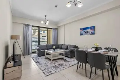 a living room with a couch and a table at Modern living nestled with 1BR_Silicon Oasis Dubai in Dubai