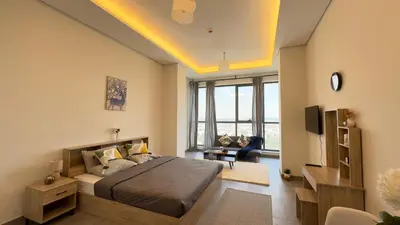 a bedroom with a bed and a living room at Private Studio Burj Khalifa Area -BEST PRICE in Dubai