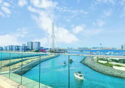 a river with boats in it with a city in the background at Luxurious Marina & Sea views 1BR near Blue Waters Dubai Marina By Maxx Value Homes in Dubai