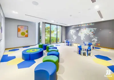 a waiting room with blue and green chairs and a world map at Luxurious Marina & Sea views 1BR near Blue Waters Dubai Marina By Maxx Value Homes in Dubai