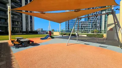 a large orange umbrella in front of a building at Luxurious Marina & Sea views 1BR near Blue Waters Dubai Marina By Maxx Value Homes in Dubai