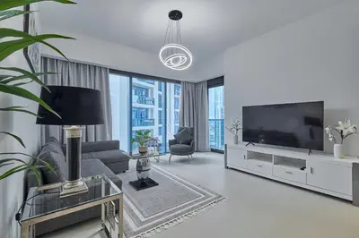 a living room with a flat screen tv and a couch at MAJESTIC Act Two 2BR- 27th Floor Burj Khalifa- Downtown Dubai in Dubai