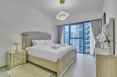 a bedroom with a large bed and a large window at MAJESTIC Act Two 2BR- 27th Floor Burj Khalifa- Downtown Dubai in Dubai