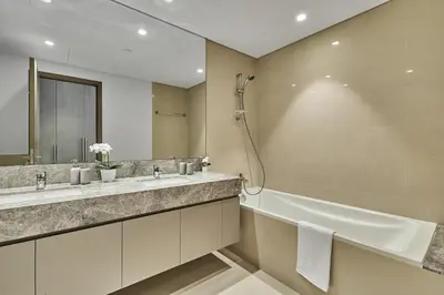 a bathroom with two sinks and a tub and a shower at MAJESTIC Act Two 2BR- 27th Floor Burj Khalifa- Downtown Dubai in Dubai