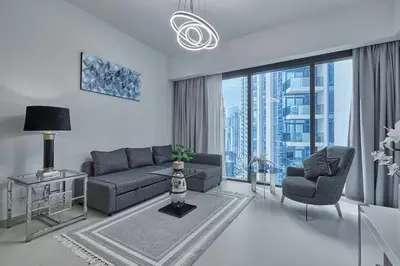 a living room with a couch and chairs and a large window at MAJESTIC Act Two 2BR- 27th Floor Burj Khalifa- Downtown Dubai in Dubai